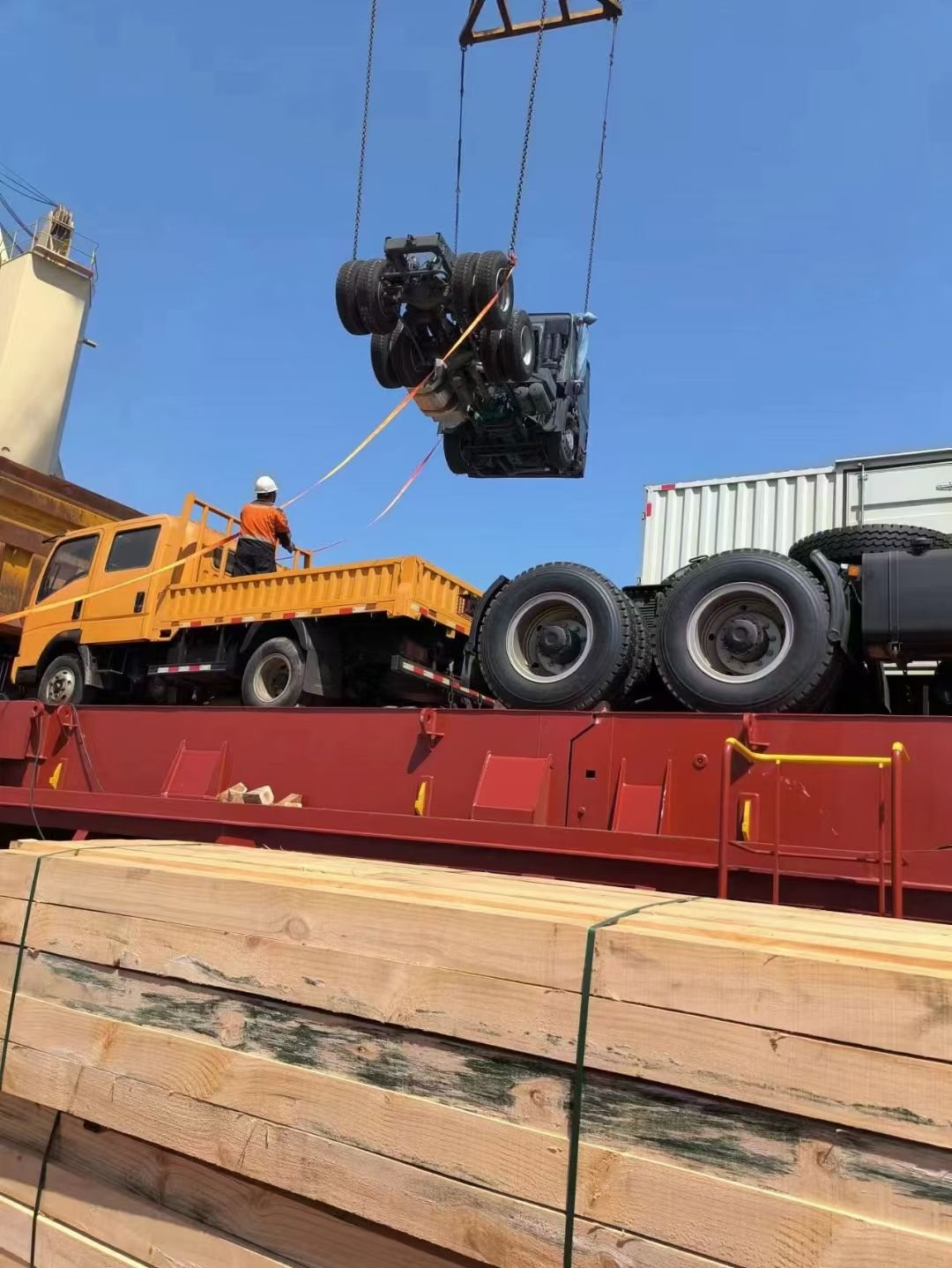 A truck tractor head landed on timber dunnage on the vessel deck ready for lashing