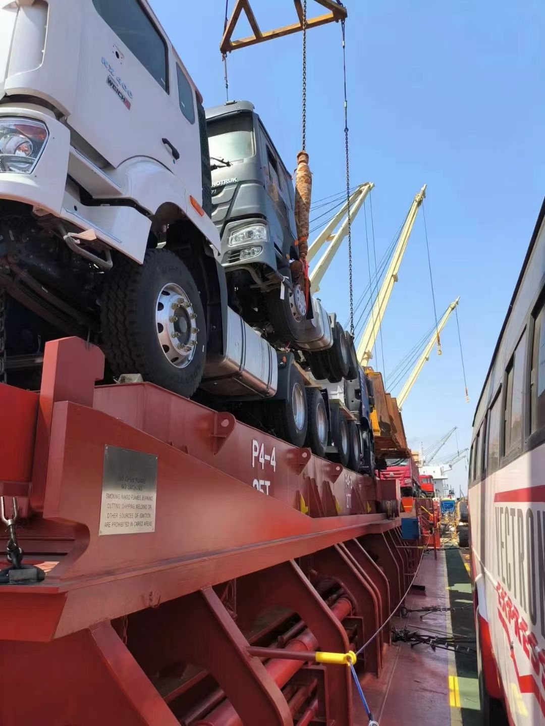 New truck tractor heads stowed on vessel trailer frames and lashed for the ocean passage